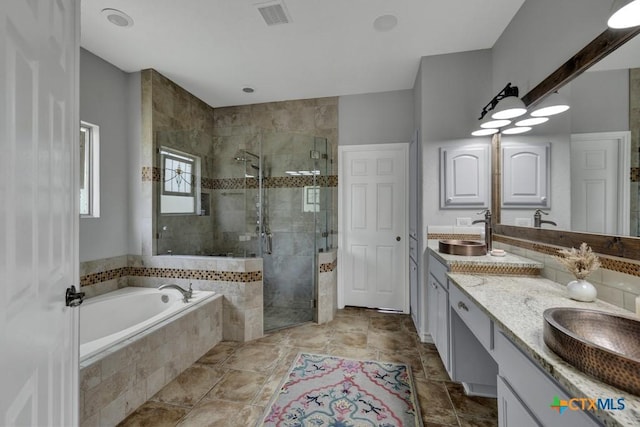 172 River Chase Dr, New Braunfels, TX 78132 - full bath with double vanity, a bath, and a shower stall