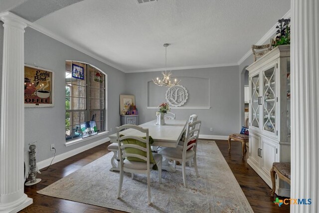 172 River Chase Dr, New Braunfels, TX 78132 - dining space featuring baseboards, dark wood finished floors, ornamental molding, ornate columns, and a textured ceiling