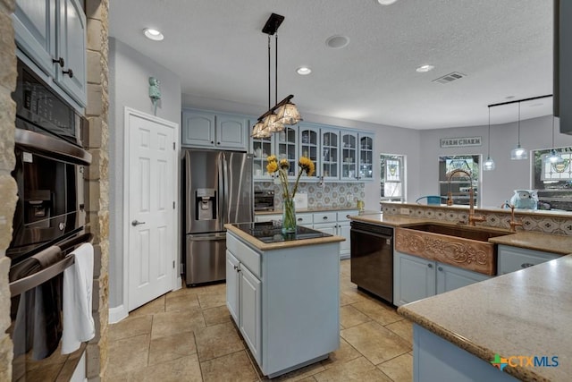 172 River Chase Dr, New Braunfels, TX 78132 - kitchen featuring black appliances, a sink, tasteful backsplash, glass insert cabinets, and recessed lighting