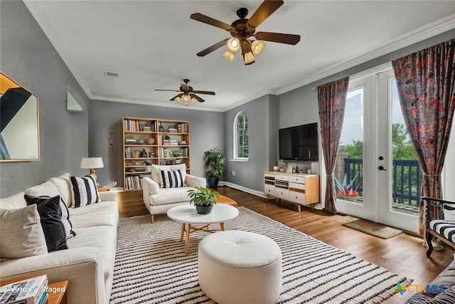 172 River Chase Dr, New Braunfels, TX 78132 - living room featuring wood finished floors, a ceiling fan, ornamental molding, french doors, and baseboards