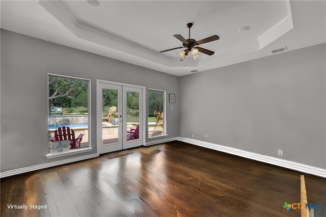 172 River Chase Dr, New Braunfels, TX 78132 - spare room featuring a tray ceiling, french doors, a ceiling fan, and wood finished floors