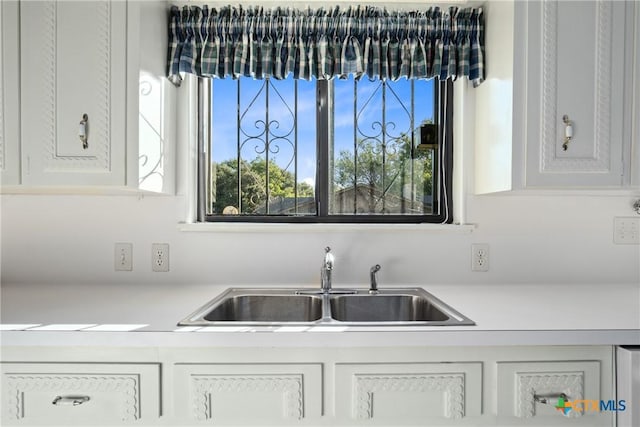 kitchen featuring sink and white cabinets