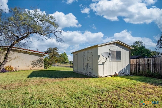 view of outdoor structure featuring a lawn