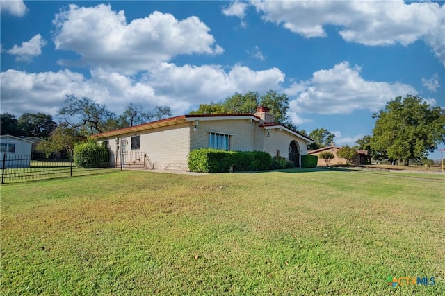 view of home's exterior with a lawn