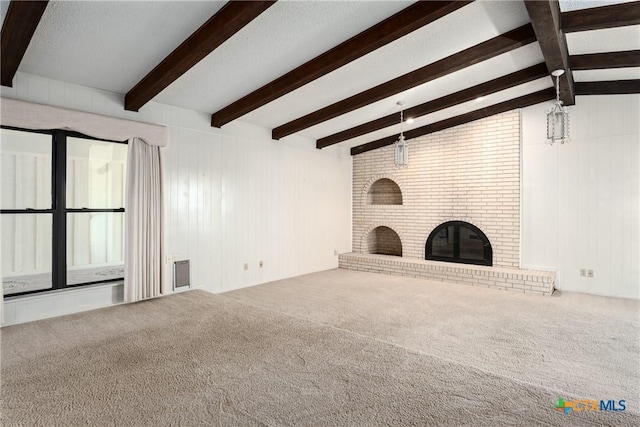 unfurnished living room with carpet, vaulted ceiling with beams, a brick fireplace, and wooden walls