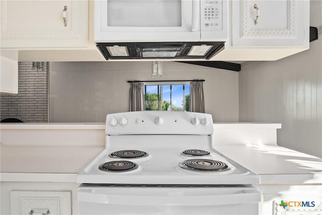 kitchen with white appliances and white cabinetry