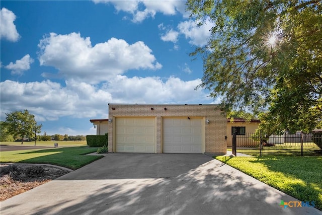 view of front of property featuring a front lawn and a garage