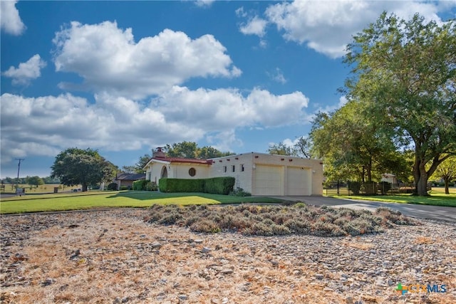 view of side of home with a garage and a yard