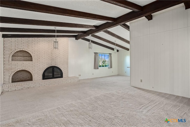 unfurnished living room with a brick fireplace, wood walls, and lofted ceiling with beams