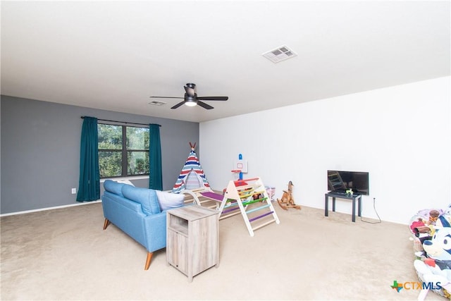 carpeted living room with ceiling fan