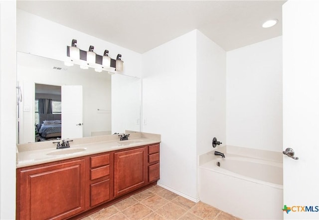 bathroom featuring vanity and a tub to relax in