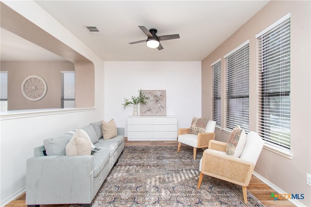 living room with ceiling fan and wood-type flooring