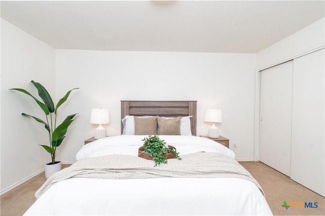 carpeted bedroom featuring a closet