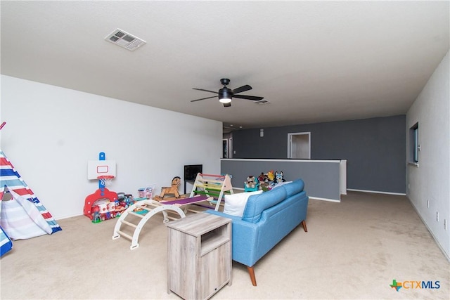 living room featuring ceiling fan and carpet