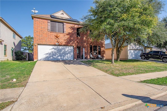 view of front property featuring a front yard, solar panels, and a garage