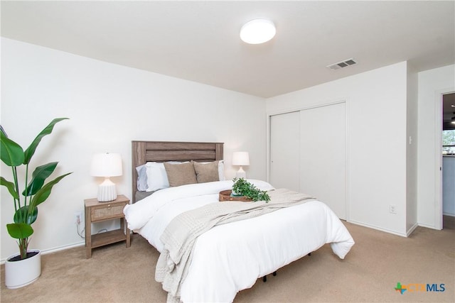 carpeted bedroom with a closet