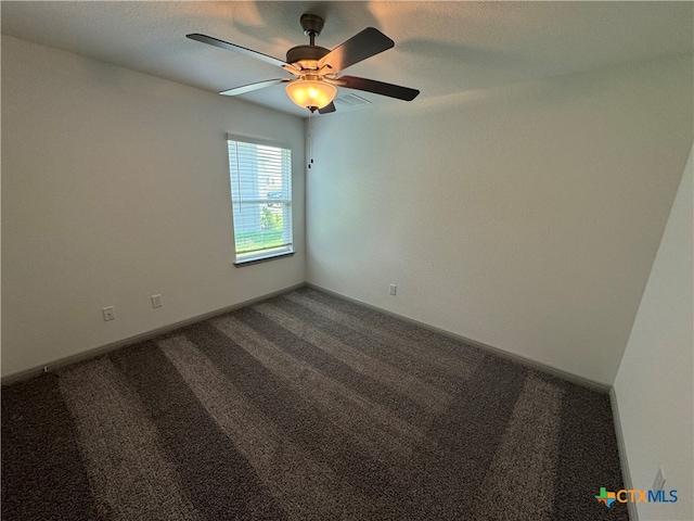 empty room featuring ceiling fan and carpet floors