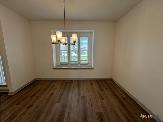 unfurnished dining area featuring a notable chandelier and dark hardwood / wood-style floors