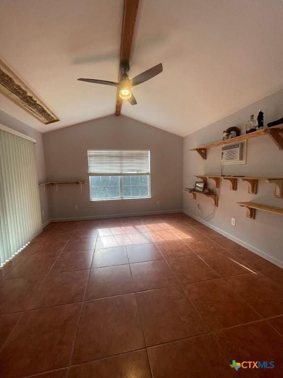 unfurnished room featuring dark tile patterned floors, vaulted ceiling with beams, and ceiling fan