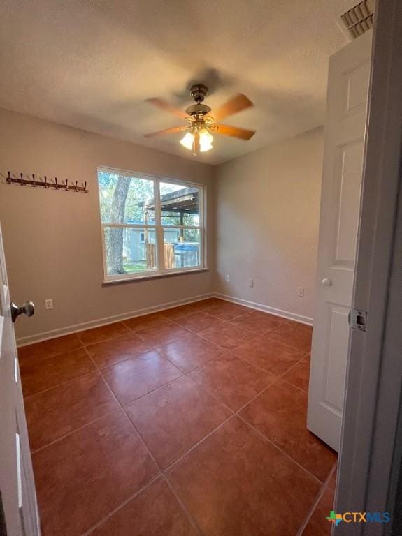 131 Oak Springs Dr, Canyon Lake, TX 78133 - unfurnished room featuring tile patterned floors, visible vents, baseboards, and ceiling fan