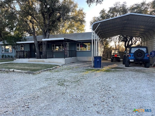 view of front of home with a carport and covered porch