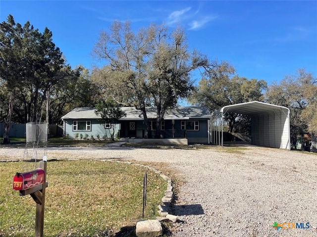 131 Oak Springs Dr, Canyon Lake, TX 78133 - single story home with a carport, a front lawn, driveway, and fence