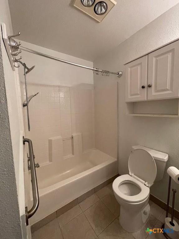 bathroom with tile patterned flooring, toilet, and shower / bath combo with shower curtain