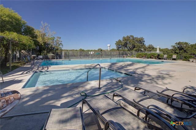 view of swimming pool featuring a patio area