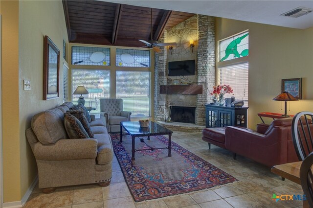 tiled living room featuring a fireplace, ceiling fan, high vaulted ceiling, wooden ceiling, and beam ceiling