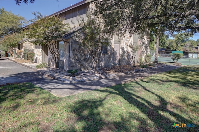 view of side of home featuring a lawn