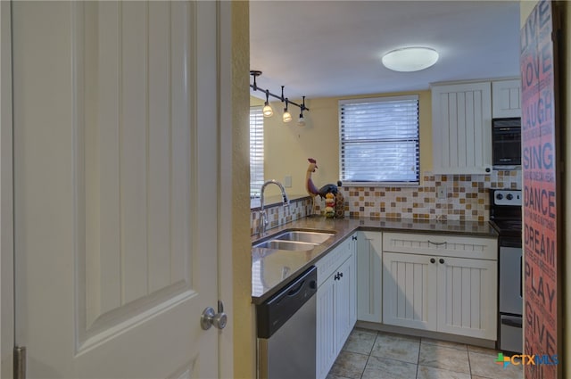 kitchen with decorative backsplash, sink, white cabinetry, and appliances with stainless steel finishes