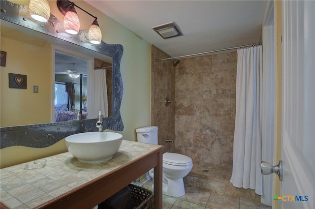 bathroom with toilet, walk in shower, and vanity