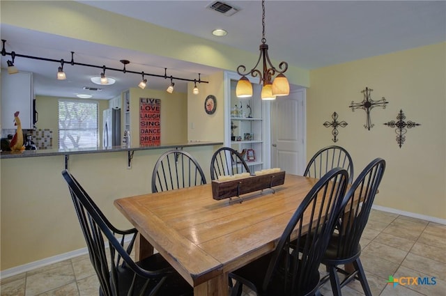 dining area with light tile patterned flooring