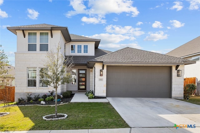 view of front of house featuring a front yard and a garage