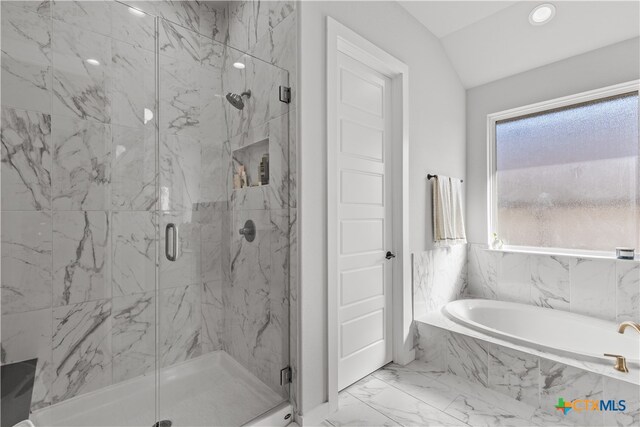 bathroom featuring shower with separate bathtub