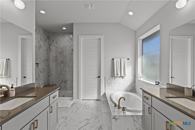 bathroom with shower with separate bathtub, vanity, and lofted ceiling