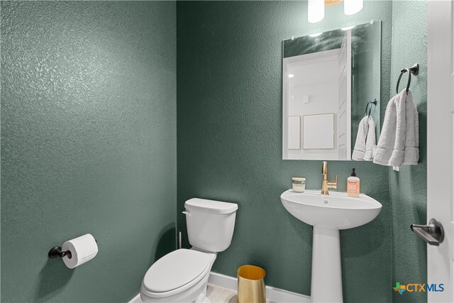 bathroom with sink and toilet