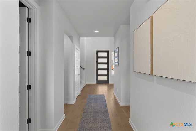 hallway with light wood-type flooring