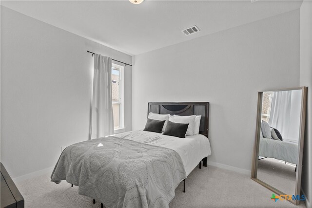 bedroom with light colored carpet