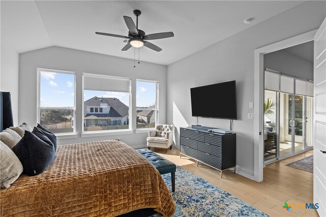 bedroom featuring access to exterior, multiple windows, ceiling fan, and light wood-type flooring