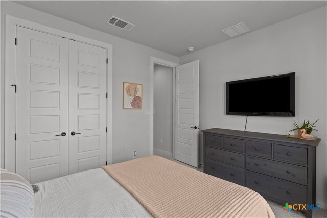 bedroom with carpet floors and a closet