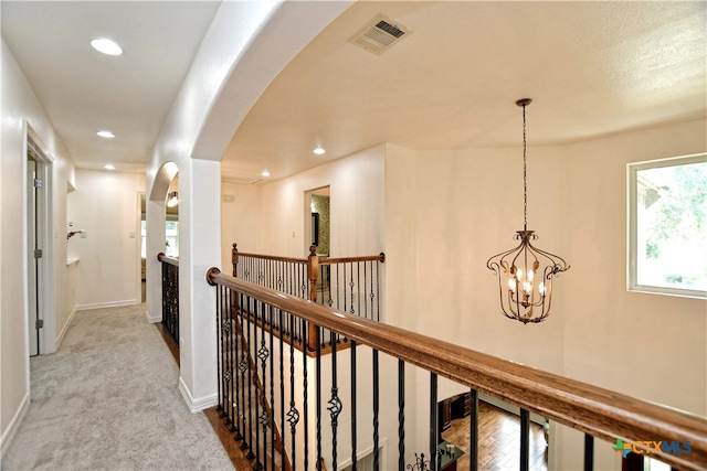 1108 Celtic Cv, Round Rock, TX 78681 - hallway with an upstairs landing, arched walkways, a chandelier, recessed lighting, and carpet