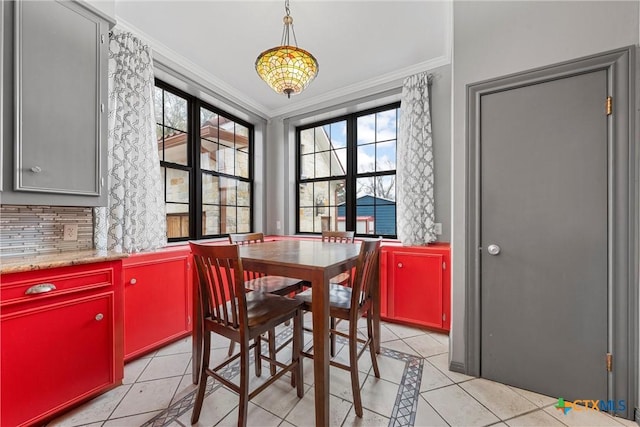 dining area featuring light tile patterned floors and ornamental molding