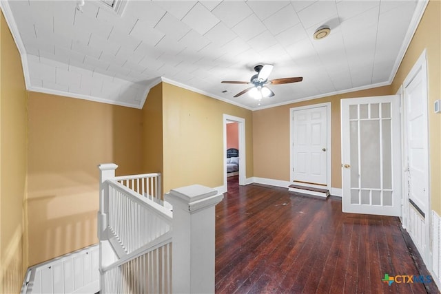 corridor featuring baseboards, an upstairs landing, hardwood / wood-style floors, and ornamental molding