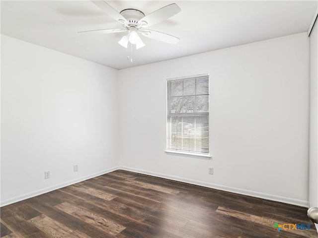 empty room with dark wood-style floors, a ceiling fan, and baseboards