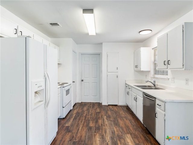 kitchen with visible vents, light countertops, white appliances, and white cabinetry