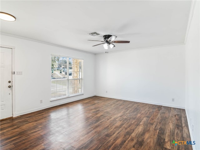 spare room featuring ceiling fan, dark wood finished floors, visible vents, and crown molding