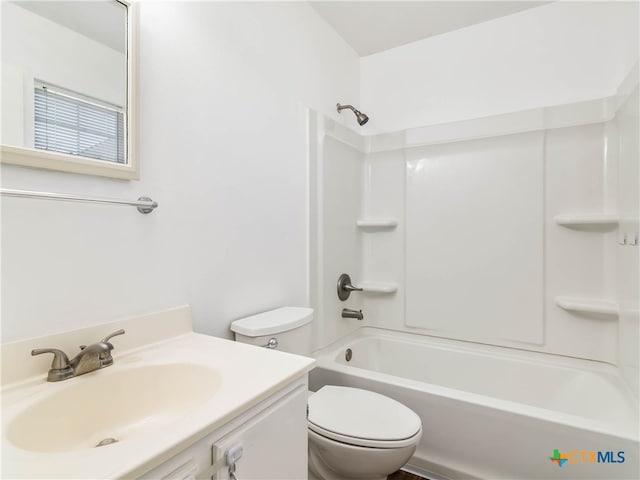 bathroom with washtub / shower combination, vanity, and toilet