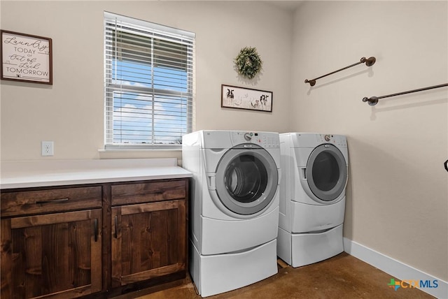 laundry area featuring cabinets and washer and dryer