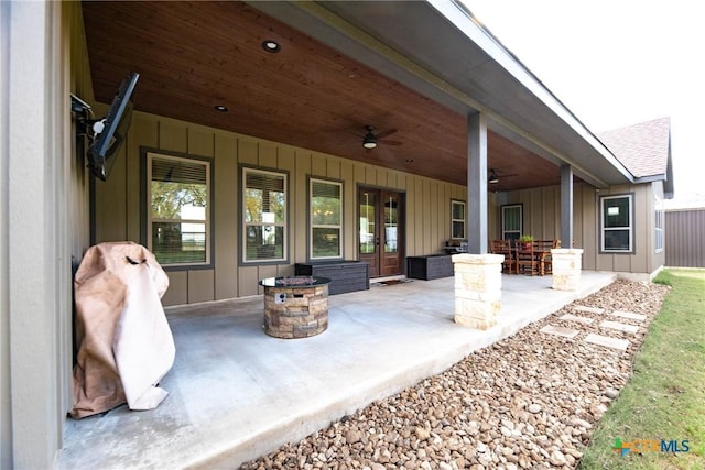 view of patio / terrace with ceiling fan and an outdoor fire pit